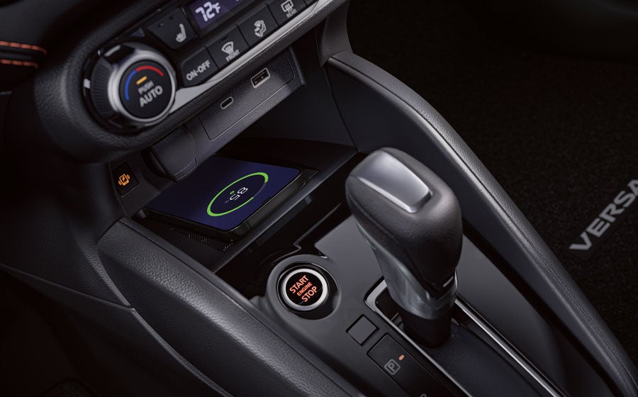 2025 Nissan Versa interior detail showing smartphone on wireless charger